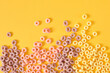 © Natasha - colorful breakfast cereals on yellow background top view