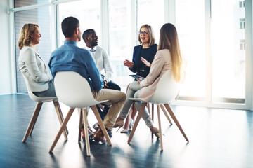 Poster - Gathered in the meeting room. Full length shot of a group of corporate colleagues meeting in their office.