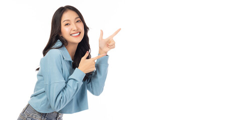 Beautiful young Asian woman pointing up to copy space and looking at camera with smile face and happy Pretty girl act like a satisfied product, use for advertising with isolated on white background