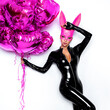 © marcink3333 - Sexy blonde woman posing in latex black costume and pink bunny mask and pink balloons on white background. Easter bunny concept. Latex lingerie. Naughty girl. Halloween costume. Woman with balloons.