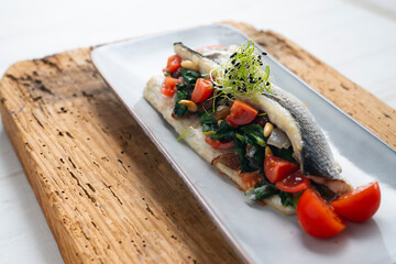 Canvas Print - Baked sea bass stuffed with spinach, raisins and pine nuts.