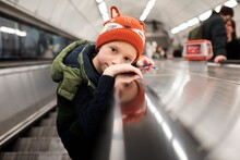 Child Playing On An Escalator In A Station In London