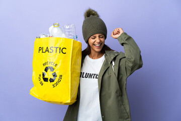 Poster - Young woman holding a bag full of plastic celebrating a victory