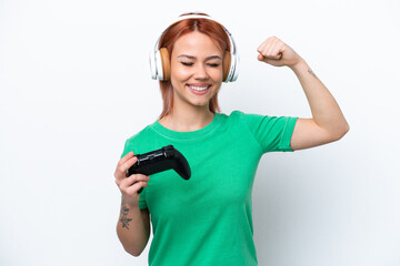 Wall Mural - Young Russian girl playing with a video game controller isolated on white background doing strong gesture