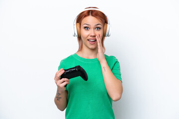 Wall Mural - Young Russian girl playing with a video game controller isolated on white background with surprise and shocked facial expression