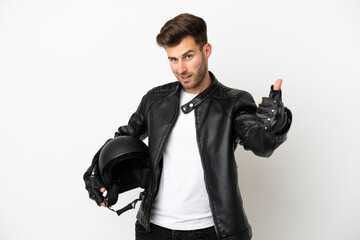 Young caucasian man with a motorcycle helmet isolated on white background with thumbs up because something good has happened