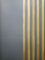 Gray vertical background with gradient and thin vertical stripes of light wood. Minimalism .