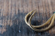 Fishing hooks close up on a wooden background.