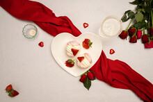 Heart-shaped Plate With Meringue And Valentines Day Decorations On Table