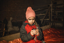 Little Ukrainian Girl Sits In A Bomb Shelter, Drinks Tea From A Thermos And Waits For The End Of The Air Attack Of Russian Invaders, Terrorism And War, Current History