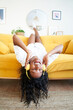 © CarlosBarquero - Vertical photo of motivated young woman listening to music with headphones sitting on sofa at home.