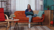 © Andrii Iemelianenko - Happy excited joyful stylish teen girl in sweater use mobile cell phone typing browsing say wow yes found out great big win news doing winner gesture. Young adult woman at home in living room on sofa