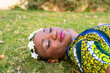 © ADDICTIVE STOCK - Black woman chilling on grass