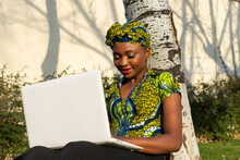 Black Woman Using Laptop In Park