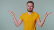 © Andrii Iemelianenko - What why. Sincere tourist adult man raising hands in indignant expression asking reason of failure demonstrating disbelief irritation by troubles. Young confused guy isolated on gray wall background