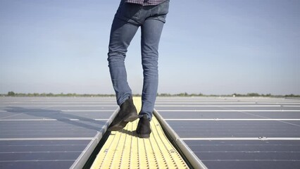 Wall Mural - african man engineer using digital tablet maintaining solar cell panels on building rooftop. technic