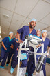 © Daniel L/peopleimages.com - Its go time. Shot of a medical team rushing through a hospital corridor.