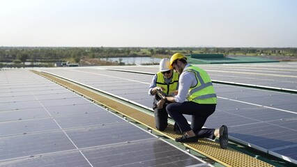 Wall Mural - professional engineer using drone and digital tablet maintaining solar cell panels together on build