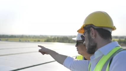 Wall Mural - professional engineer using drone and digital tablet maintaining solar cell panels together on build