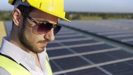 Wall Mural - professional man engineer using tablet maintaining solar cell panels on building rooftop. technician