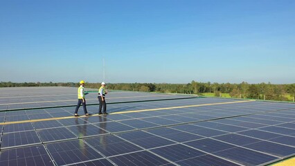 Wall Mural - professional engineer using drone and digital tablet maintaining solar cell panels together on build
