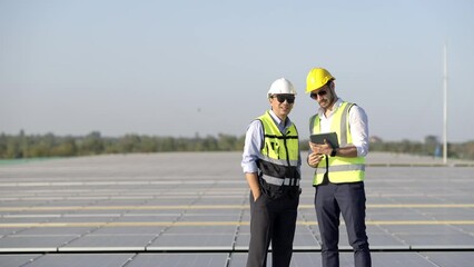Wall Mural - professional engineer using drone and digital tablet maintaining solar cell panels together on build
