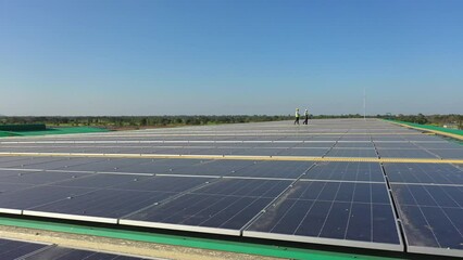 Wall Mural - professional engineer using drone and digital tablet maintaining solar cell panels together on build