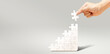 © kardd - Step by Step to Build Up Future with your own hands concept, Hand fill white jigsaw puzzle to fulfill the puzzle