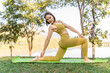 © kudosstudio - Young attractive and active woman practicing her morning yoga outdoor at a local lake park
