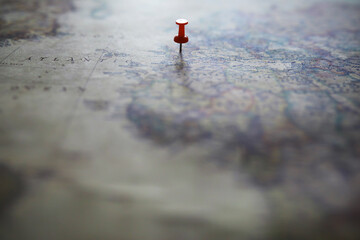 Travel concept. Map and needle with a marked place. Compass point on the map and routes.