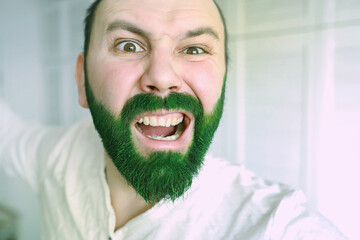 Happy saint patricks day. A man with a green beard. St.Patrick 's Day. Irish fan color beard.