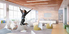 Portrait Of Energetic Businesswoman Jumping In Open Air