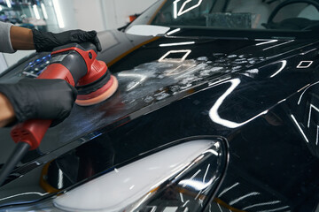 Wall Mural - Experienced service station worker polishing motor vehicle