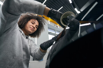 Wall Mural - Concentrated service station worker choosing car polishing tool