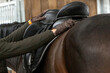 An equestrian saddle up a horse; close-up of a rider scenery