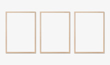 Photo Frame Mockup. Set Of Three Vertical Oak Wooden Frames On White Wall. Template For Artwork, Painting Or Poster.