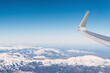 © Westend61 - Airplane flying over snow covered white mountains on sunny day