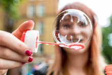 Young Woman Showing Soap Bubble