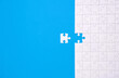 © rangizzz - Unfinished white jigsaw puzzle isolated on blue background with copy space