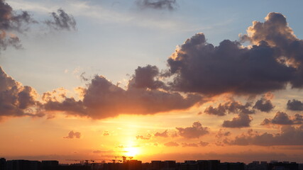 Wall Mural - the beautiful sunset view with the colorful clouds and sky in the city