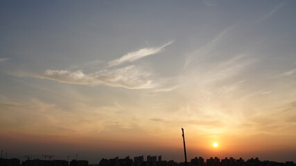Wall Mural - the beautiful sunset view with the colorful clouds and sky in the city