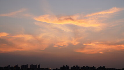 Wall Mural - the beautiful sunset view with the colorful clouds and sky in the city