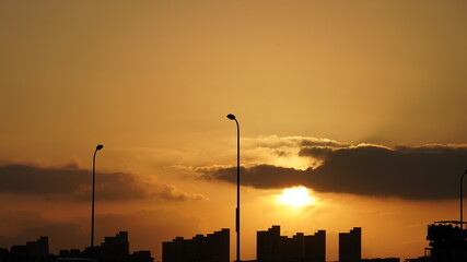Wall Mural - the beautiful sunset view with the colorful clouds and sky in the city