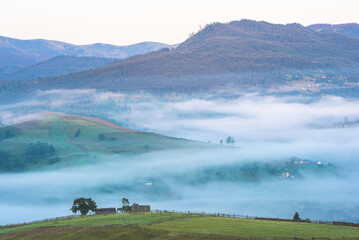 View of alpine village covered with blue fog 1