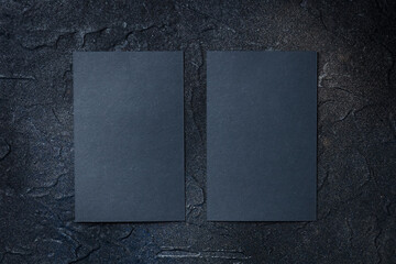 Wall Mural - Black business cards mockup, front and back, vertical, on a dark background, a template for design presentation, thick cardboard