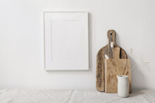 Portrait Picture Frame Mockup. Wooden Chopping Boards And Vase With Dry Lagurus Grass. Beige Linen Tablecloth. White Wall Background. Scandinavian Interior Still Life. Home Design. Art Concept.