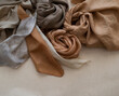hand dyed clothes in warm natural tones on a bright background - text space -
slow fashion concept 