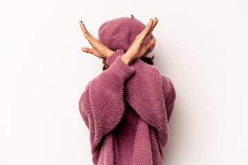 Young hispanic woman isolated on white background keeping two arms crossed, denial concept.