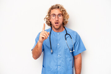 Wall Mural - Young nurse caucasian man isolated on white background having an idea, inspiration concept.