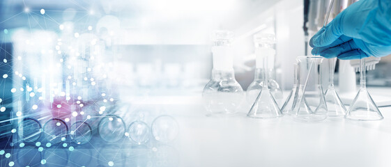 Wall Mural - hand of scientist with test tube and flask in medical chemistry lab banner background.